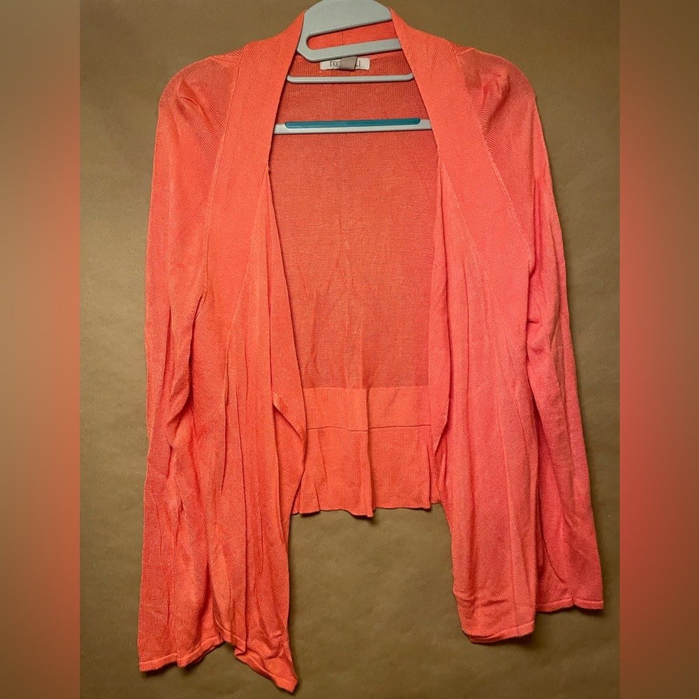 Coral colored cardigan. Angled longer in the front. Light weight